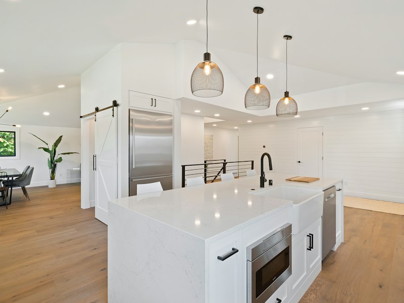 Contractor reviewing kitchen design plans with homeowners